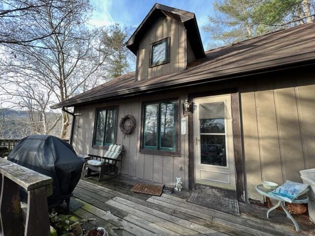 wooden terrace featuring grilling area