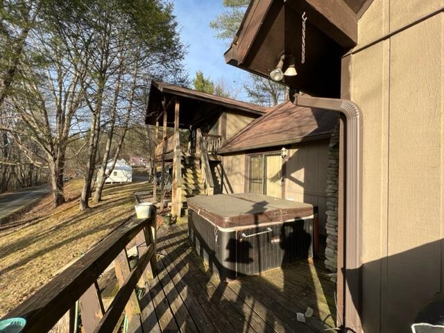 wooden terrace with a hot tub