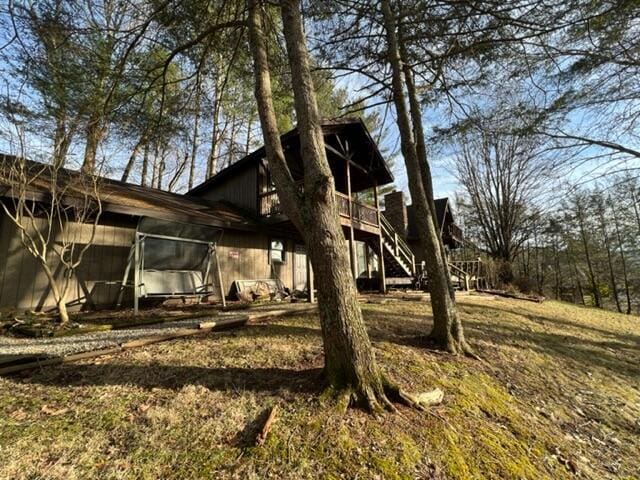 view of side of property featuring stairway