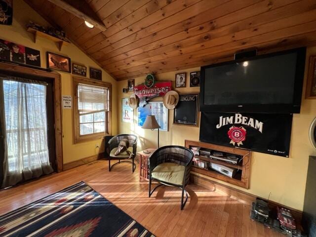 sitting room with wooden ceiling, vaulted ceiling, and wood finished floors