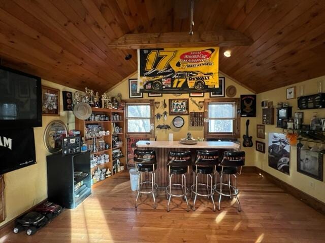 bar featuring lofted ceiling, wood finished floors, and wood ceiling