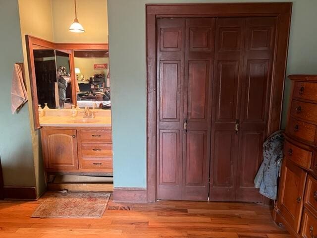 bathroom with vanity and wood finished floors