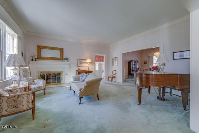 living room with ornamental molding, light colored carpet, and a glass covered fireplace