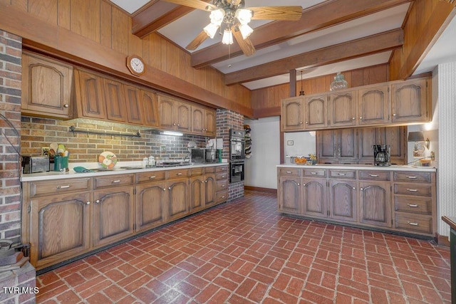 kitchen with black appliances, brick floor, light countertops, and decorative backsplash