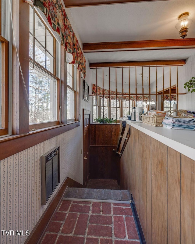 stairs featuring a fireplace and beam ceiling