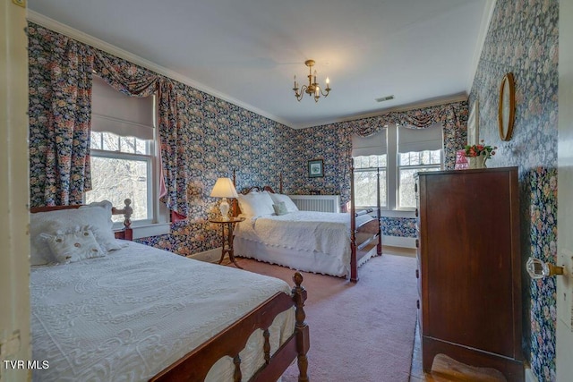 carpeted bedroom with wallpapered walls, multiple windows, visible vents, and crown molding