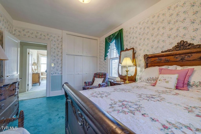 bedroom featuring wallpapered walls, carpet, multiple windows, and a closet