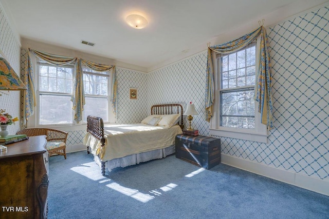 bedroom featuring wallpapered walls, baseboards, visible vents, and carpet flooring