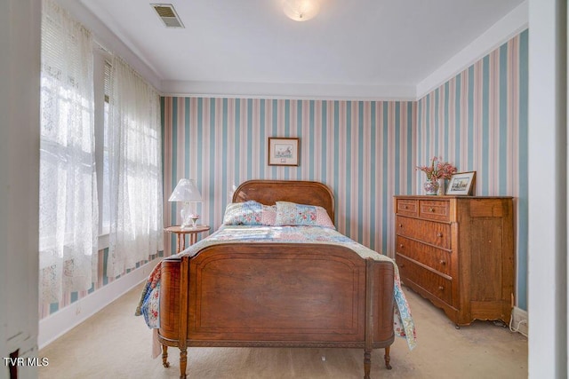 bedroom featuring baseboards, visible vents, and wallpapered walls