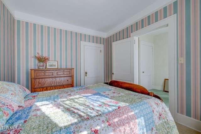 bedroom with carpet flooring and wallpapered walls