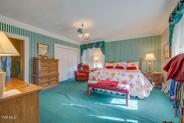 bedroom with a notable chandelier, a closet, carpet, and wallpapered walls