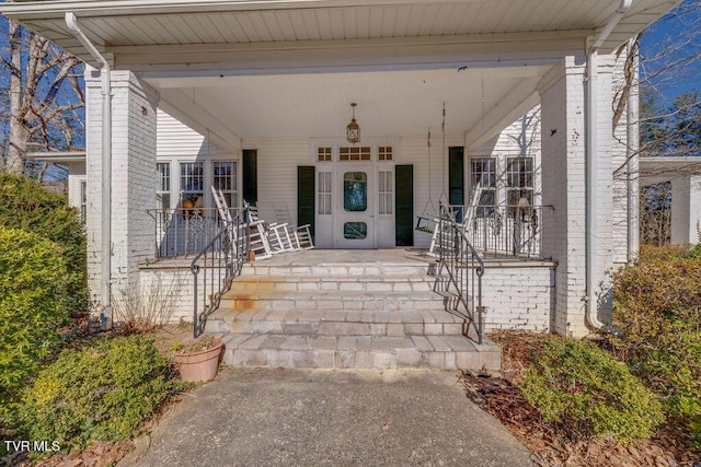 property entrance featuring brick siding