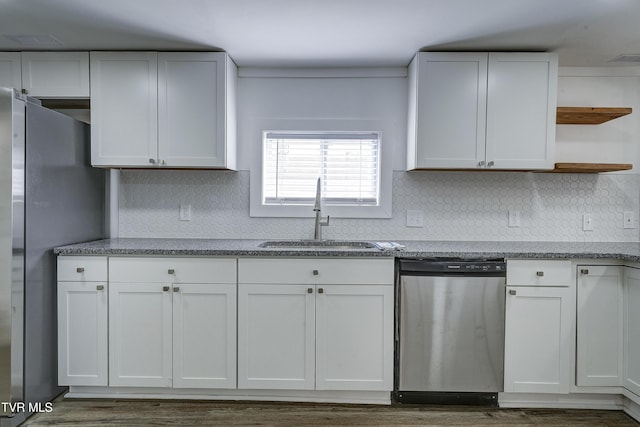 kitchen featuring appliances with stainless steel finishes, light stone countertops, white cabinetry, open shelves, and a sink