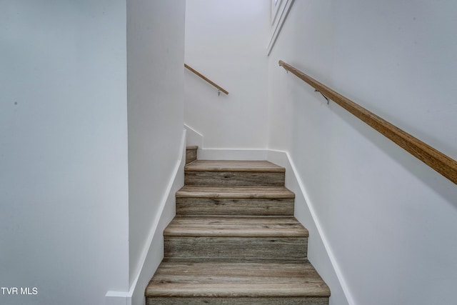 stairs with wood finished floors