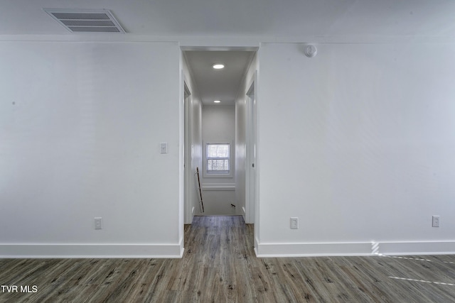 interior space with wood finished floors, visible vents, and baseboards