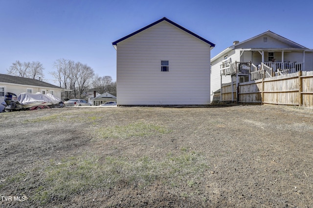 view of property exterior with fence and driveway