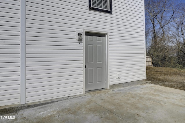 entrance to property featuring a patio