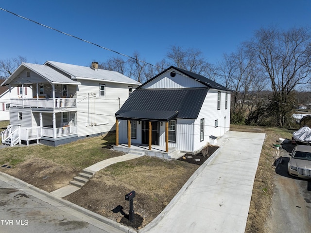 view of front facade with covered porch and metal roof