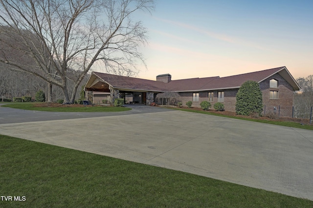 ranch-style home with driveway and brick siding