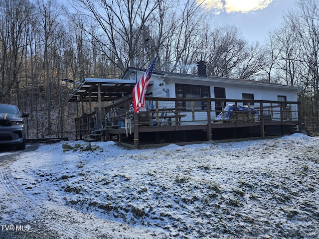 view of front of property with a deck and a chimney