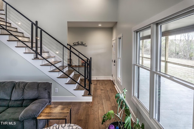 entryway with stairway, baseboards, and dark wood finished floors