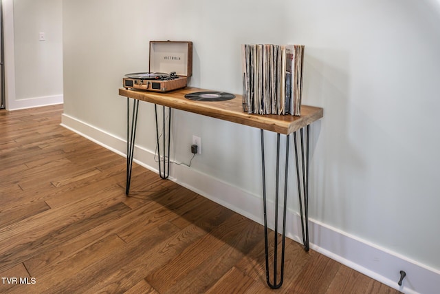 interior space featuring baseboards and wood finished floors