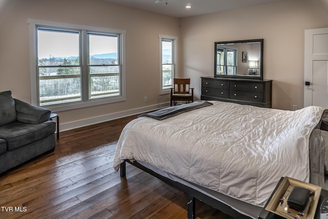 bedroom with baseboards, dark wood-type flooring, and recessed lighting