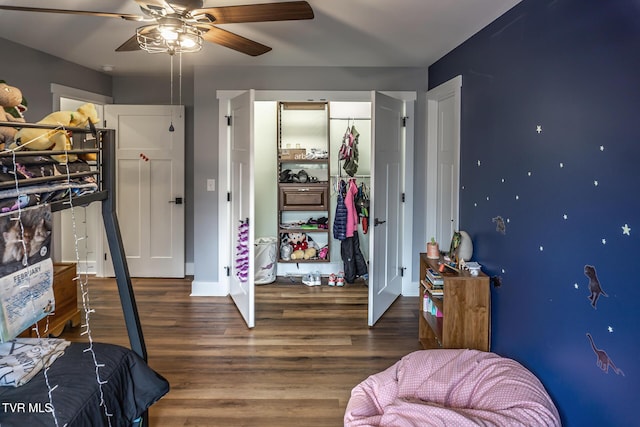 bedroom with a closet, wood finished floors, and a ceiling fan