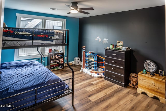 bedroom with a ceiling fan and wood finished floors