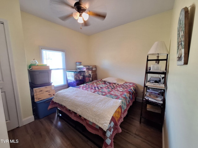 bedroom featuring ceiling fan, wood finished floors, and baseboards