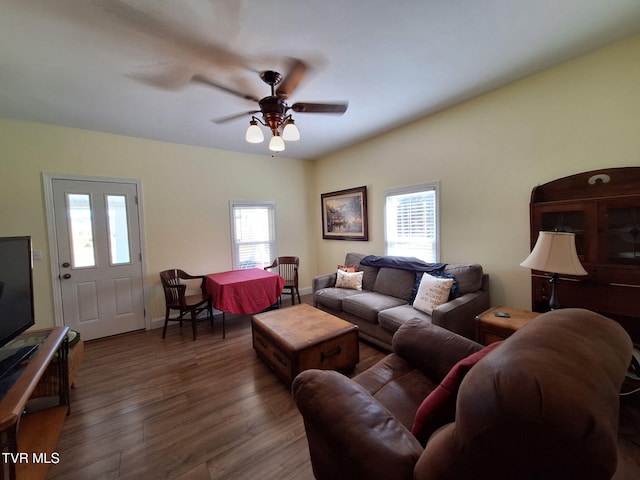 living room with wood finished floors and a ceiling fan