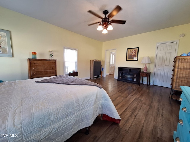 bedroom featuring ceiling fan, wood finished floors, and baseboards