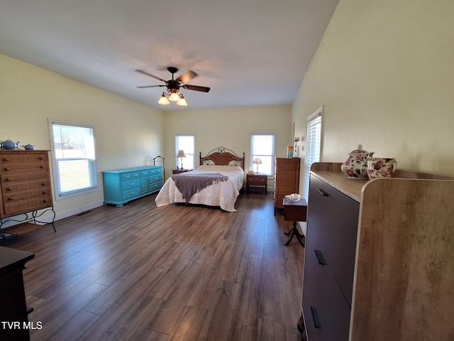 bedroom featuring dark wood-style floors, ceiling fan, and baseboards