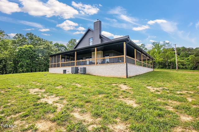 2150 Sunnyside Rd, Greeneville, TN 37743 - rear view of property featuring a chimney, a lawn, central air condition unit, and a sunroom
