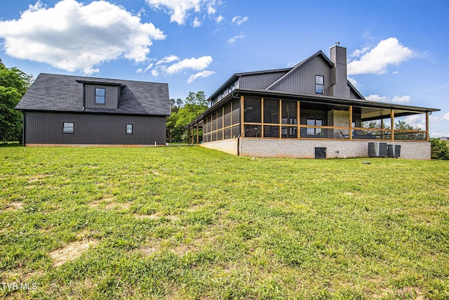2150 Sunnyside Rd, Greeneville, TN 37743 - rear view of house with a sunroom, a lawn, a chimney, and cooling unit