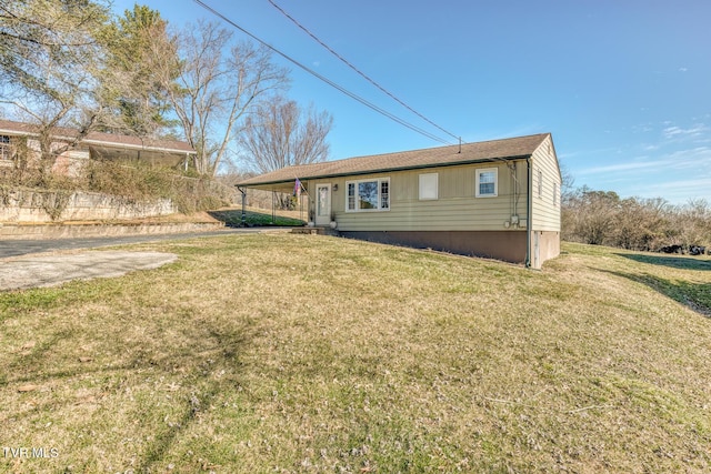 back of property featuring a yard