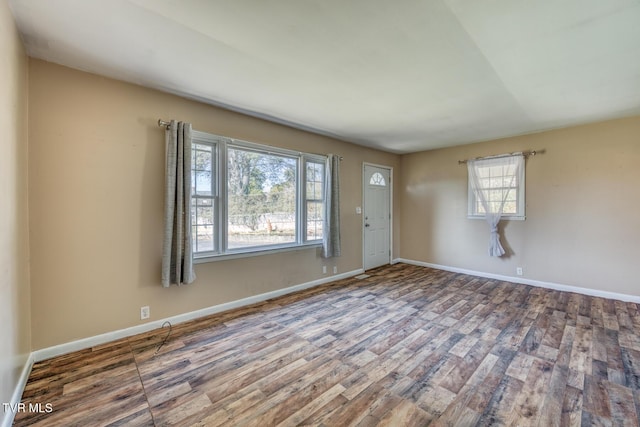 interior space with wood finished floors and baseboards