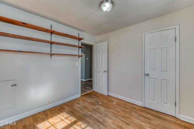 unfurnished bedroom featuring light wood-style flooring and baseboards