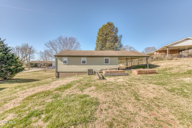 back of house featuring a vegetable garden, cooling unit, and a yard