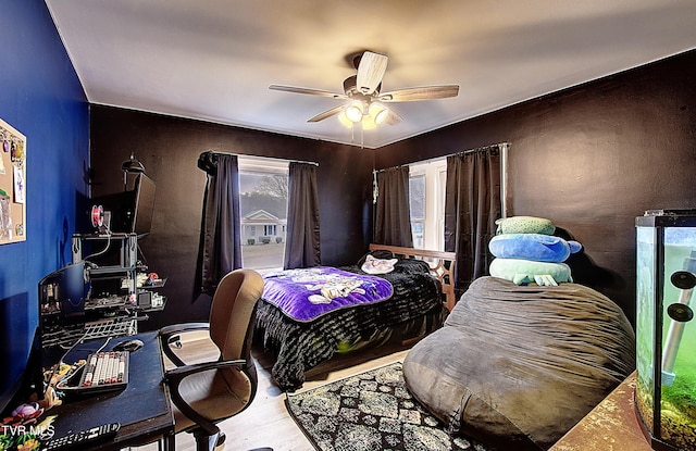 bedroom with ceiling fan and wood finished floors