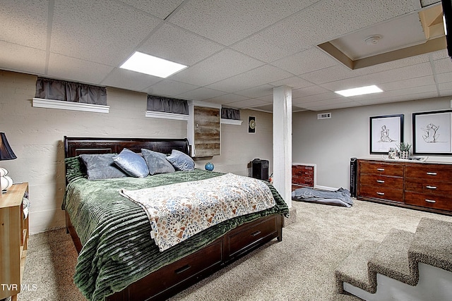 bedroom featuring a paneled ceiling, carpet flooring, visible vents, and baseboards