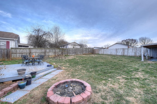 view of yard featuring an outdoor fire pit, a fenced backyard, and a wooden deck