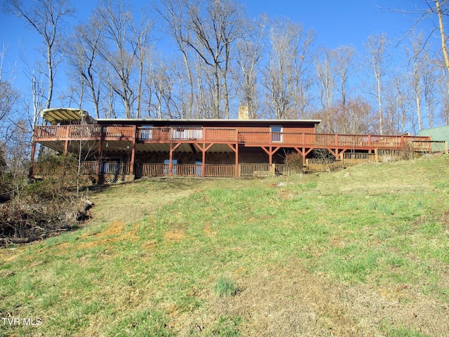 exterior space featuring a wooden deck and a front yard