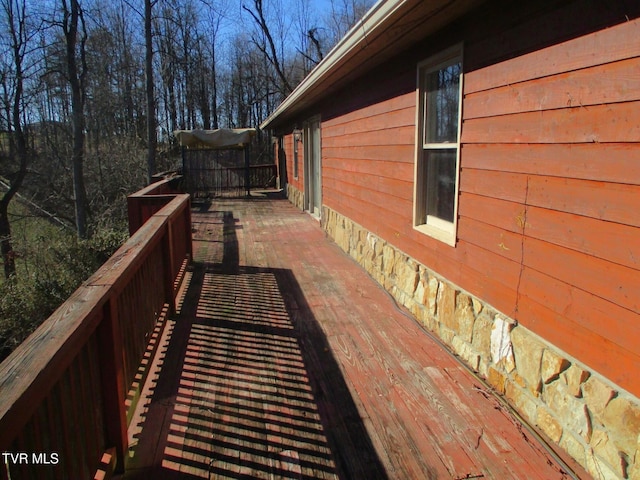 view of property exterior with a wooden deck