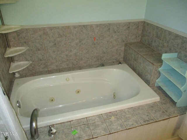 full bathroom with a tub with jets