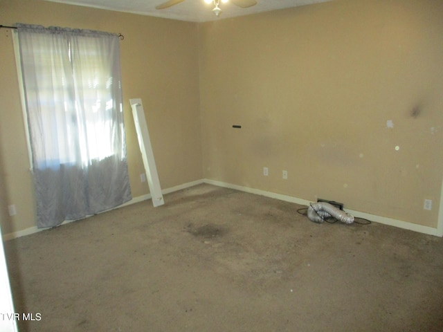 spare room featuring baseboards and a ceiling fan