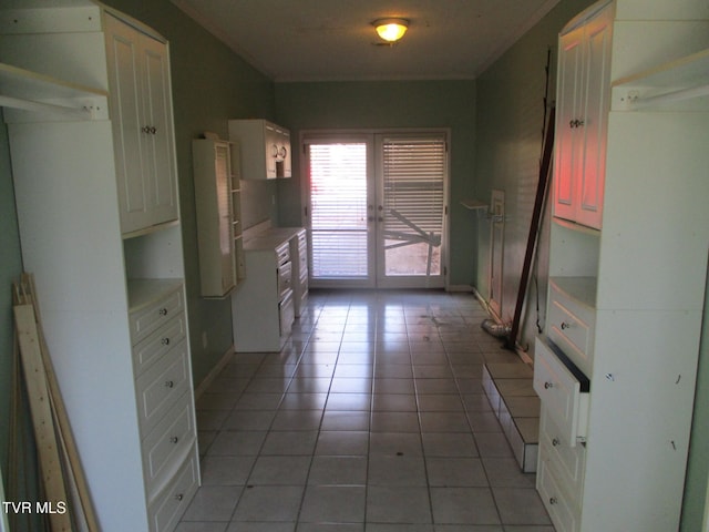 kitchen with tile patterned flooring, light countertops, and french doors