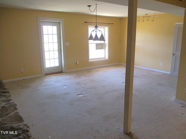 unfurnished dining area with light carpet and baseboards