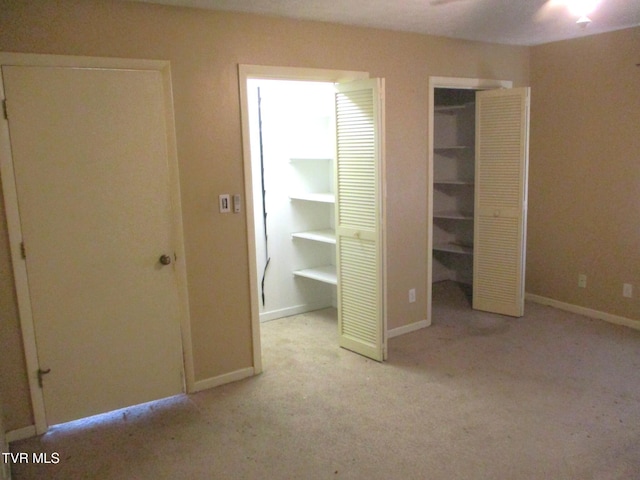 unfurnished bedroom with light carpet and baseboards