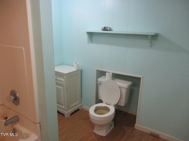 bathroom featuring toilet, baseboards, and wood finished floors